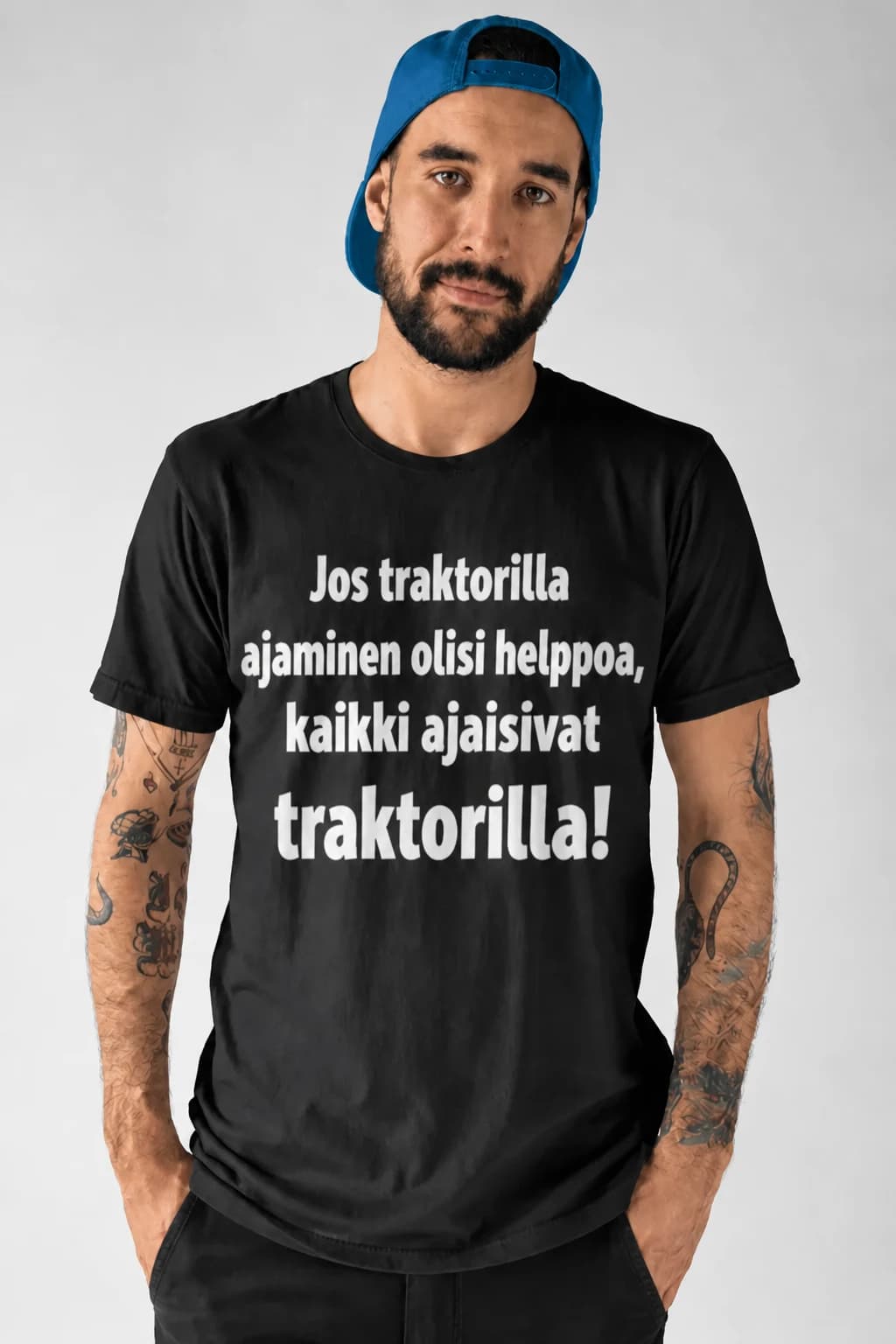Mies mustassa T-paidassa, jossa teksti Jos traktorilla ajaminen olisi helppoa kaikki ajaisivat traktorilla